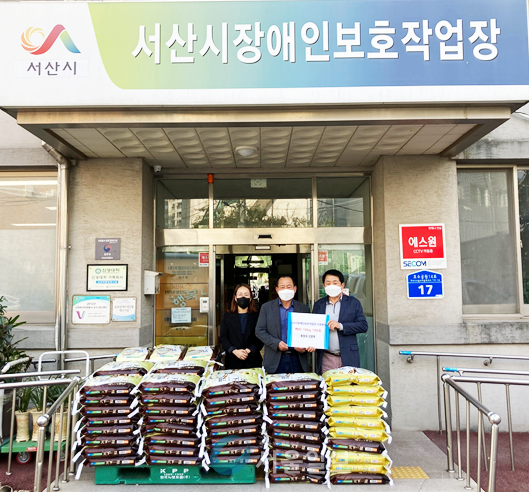 21일 오병택씨(사진 중앙)는 서산시장애인보호작업장을 찾아 쌀100포을 전달 했다.(사진제공/서산시장애인보호작업장)